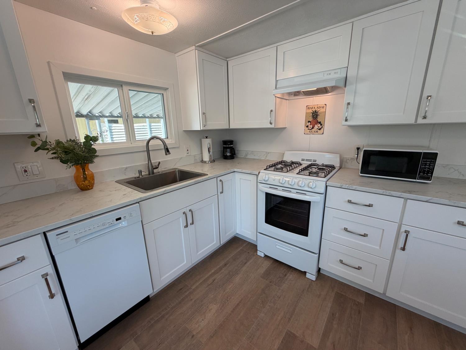 9060 Auburn Folsom Road, Unit 19 Granite Bay, CA 95746 - Photo 5 of 30 a kitchen with cabinets appliances a sink and a window