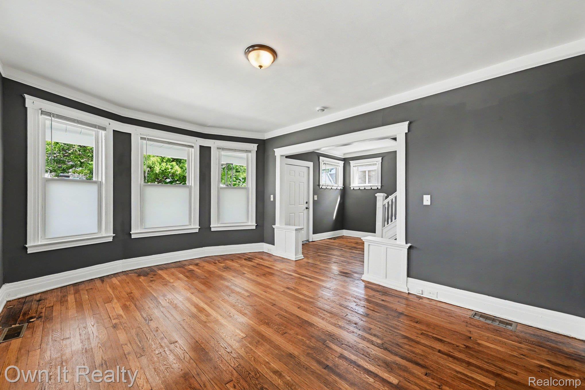44 Maple Street River Rouge, MI 48218 - Photo 5 of 33 Hardwood flooring throughout, featuring a bay window with three sashes