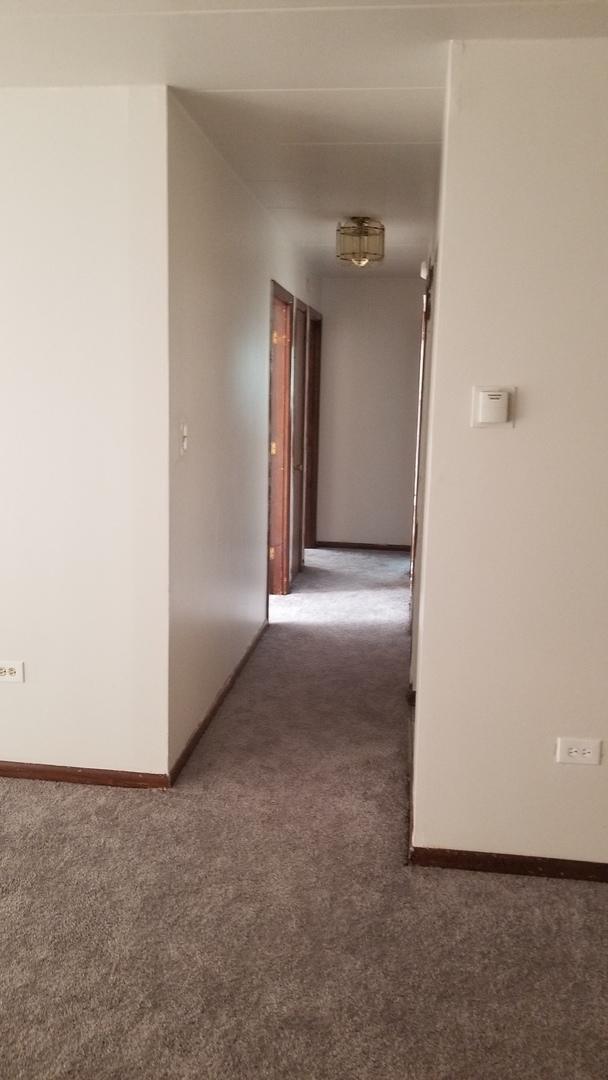 18550 Torrence Avenue, Unit 19 Lansing, IL 60438 - Photo 2 of 8 a view of a big room with closet and windows