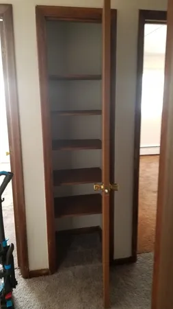 a view of walk in closet with empty racks