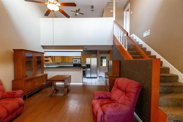 a living room with furniture and a wooden floor