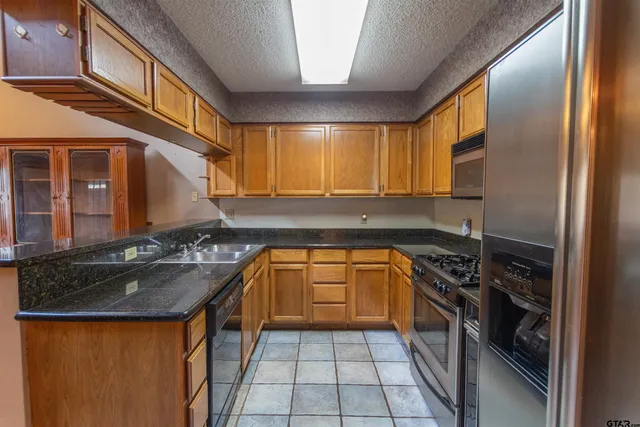 a kitchen that has a sink and a stove