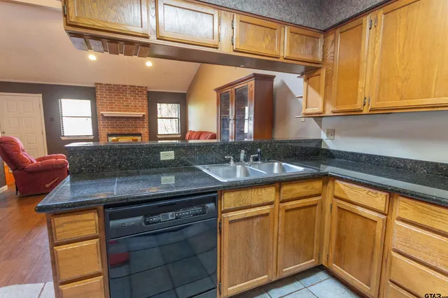 a kitchen with stainless steel appliances granite countertop a sink and cabinets