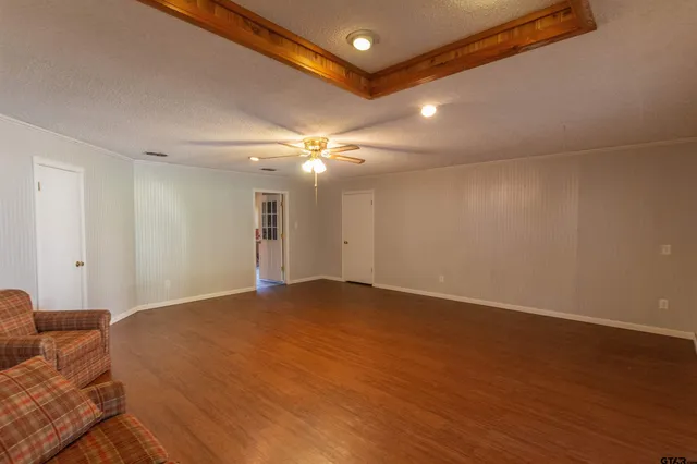 a view of a livingroom with a ceiling fan and window