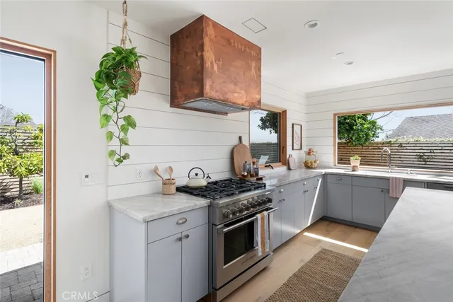 a view of a backyard with potted plants and a fountain