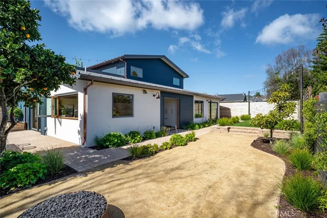 a living room with furniture floor to ceiling window and a flat screen tv