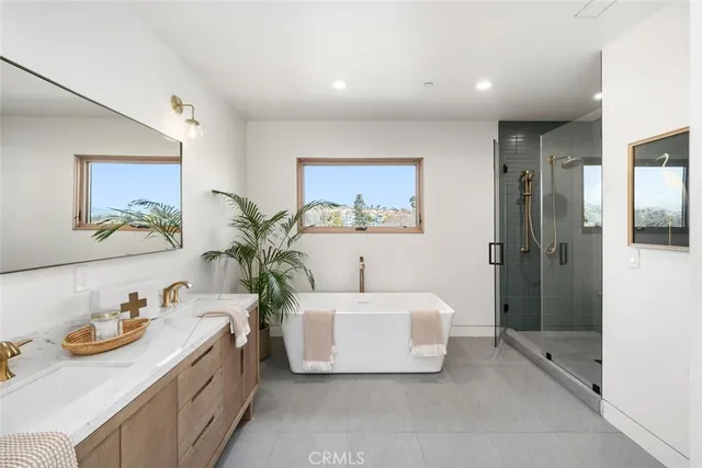 a bathroom with a toilet sink vanity tub and mirror