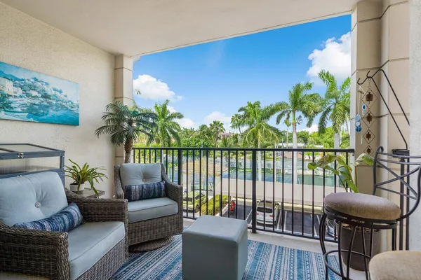 a view of a dining room with furniture a chandelier and wooden floor
