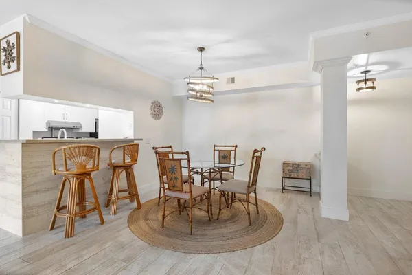 a kitchen with a sink cabinets and wooden floor
