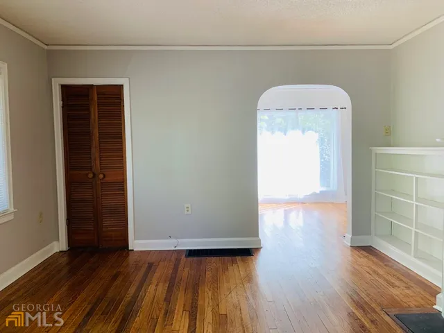 a view of a room with wooden floor