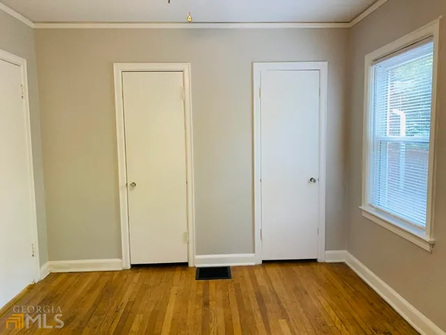 a view of a room with a window and a ceiling fan