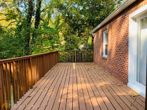 a view of backyard with a deck and wooden floor