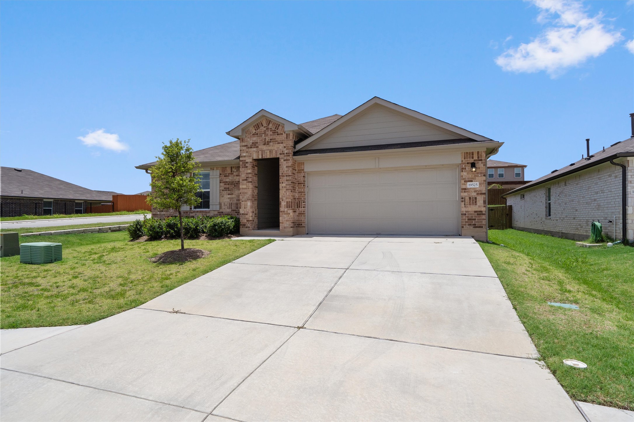 19525 Abigail Fillmore Road Manor, TX 78653 - Photo 34 of 38 A welcoming facade with a concrete driveway leads to this charming residence featuring brick and siding construction.