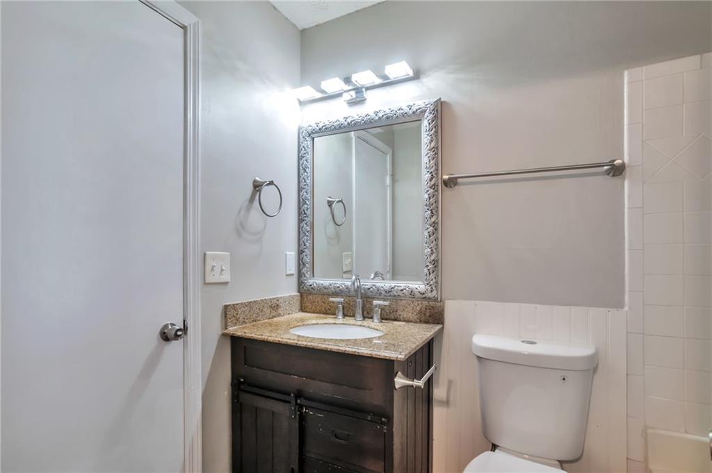 5918 Crescent Ridge Court Lithonia, GA 30058 - Photo 11 of 25 a bathroom with a sink vanity mirror and toilet