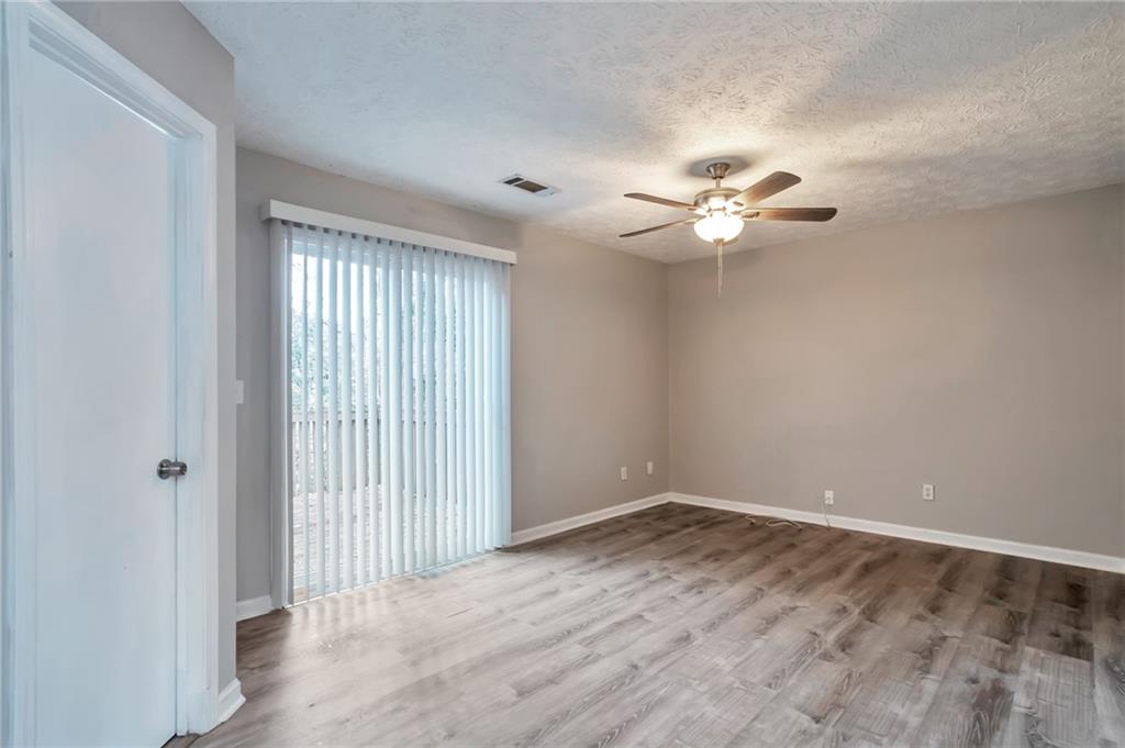 5918 Crescent Ridge Court Lithonia, GA 30058 - Photo 13 of 25 wooden floor in an empty room with a window