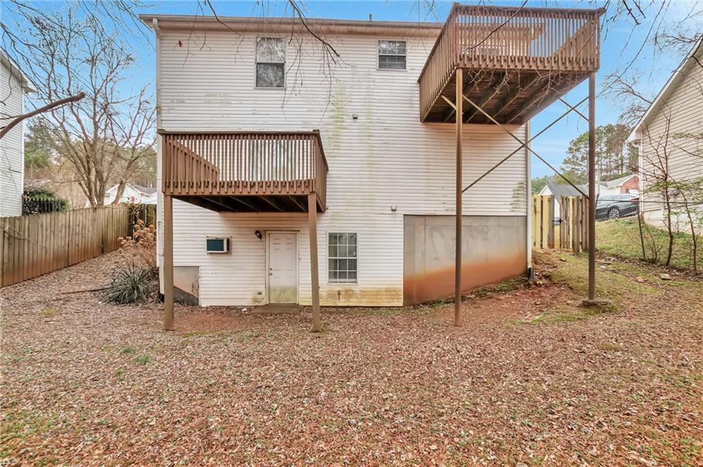 5918 Crescent Ridge Court Lithonia, GA 30058 - Photo 23 of 25 a view of a house with a wooden fence