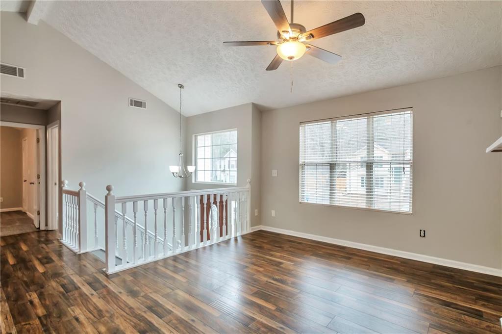 5918 Crescent Ridge Court Lithonia, GA 30058 - Photo 4 of 25 a view of an empty room with wooden floor and a window