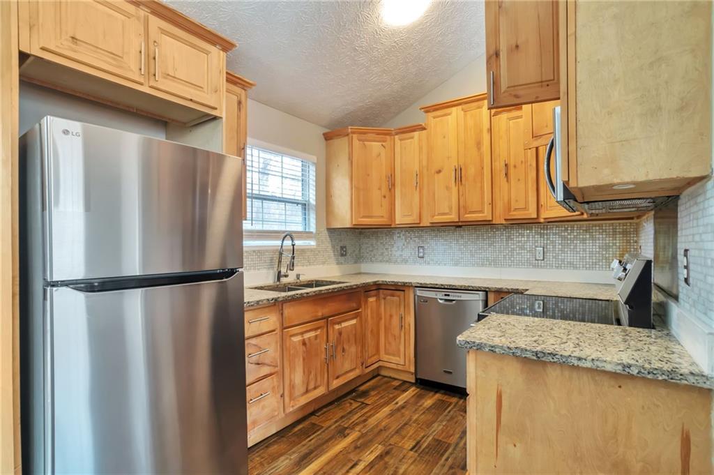 5918 Crescent Ridge Court Lithonia, GA 30058 - Photo 6 of 25 a kitchen with a refrigerator a sink and cabinets