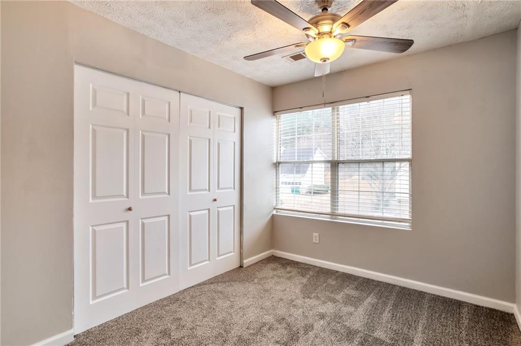 5918 Crescent Ridge Court Lithonia, GA 30058 - Photo 8 of 25 an empty room with windows and fan