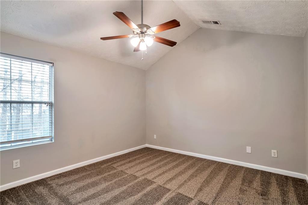 5918 Crescent Ridge Court Lithonia, GA 30058 - Photo 9 of 25 an empty room with a window and a ceiling fan