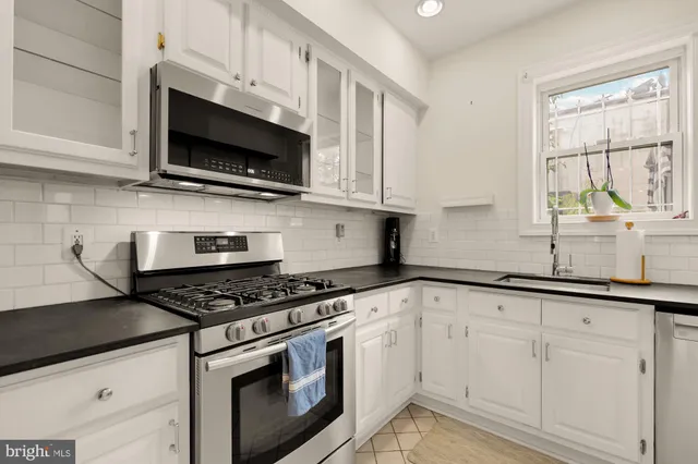 a view of a hallway with wooden floor and cabinet