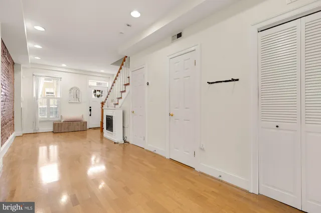 a view of an empty room with stairs and a window