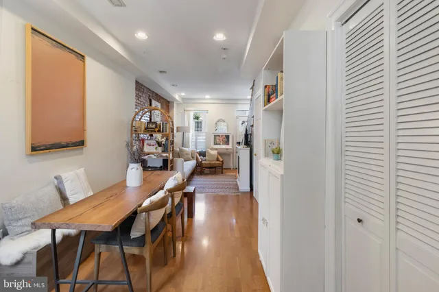 a view of a room with furniture and wooden floor