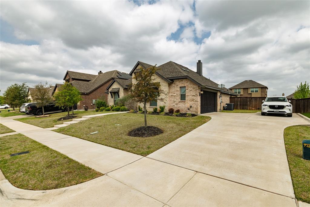 4045 Grove Valley Road Midlothian, TX 76065 - Photo 3 of 34 French provincial home with a chimney, brick siding, concrete driveway, a residential view, and a garage