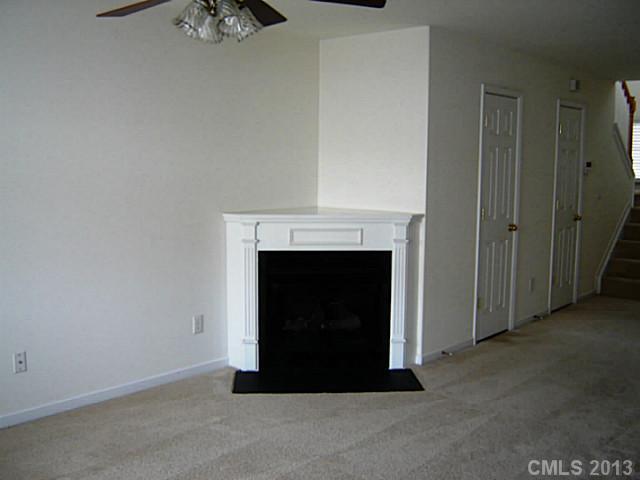 11638 Rabbit Ridge Road, Unit 11638 Charlotte, NC 28270 - Photo 4 of 15 a view of an empty room with a fireplace