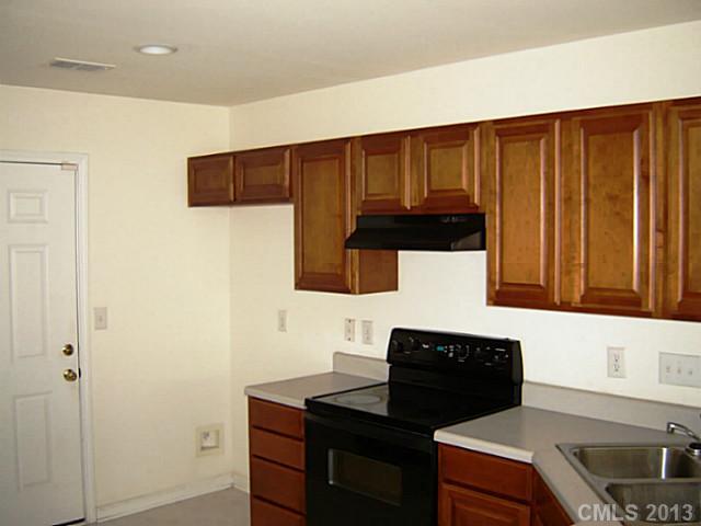 11638 Rabbit Ridge Road, Unit 11638 Charlotte, NC 28270 - Photo 5 of 15 a kitchen with a sink and a cabinets