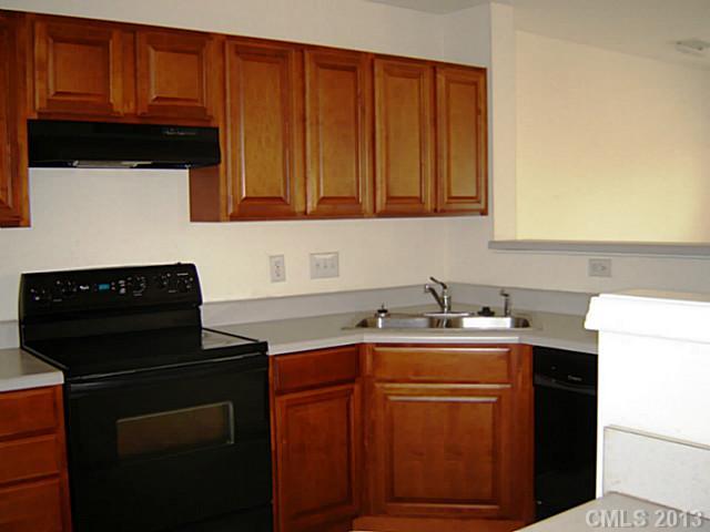 11638 Rabbit Ridge Road, Unit 11638 Charlotte, NC 28270 - Photo 6 of 15 a kitchen with a sink dishwasher stove and cabinets