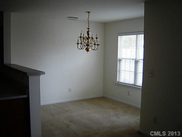 11638 Rabbit Ridge Road, Unit 11638 Charlotte, NC 28270 - Photo 8 of 15 an empty room with windows and cabinet