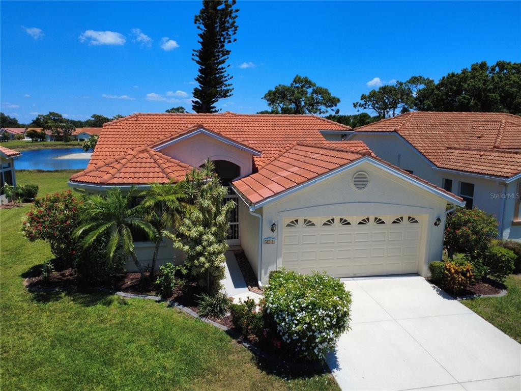 4266 Summertree Road Venice, FL 34293 - Photo 2 of 64 a front view of house with yard and trees in the background