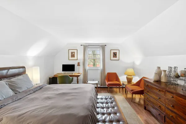 a bedroom with furniture and a window