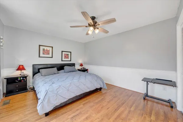 a bedroom with a bed window and a chandelier
