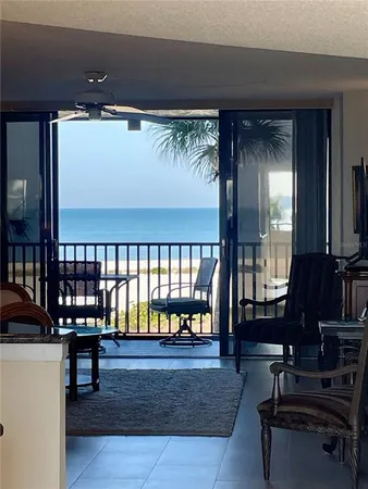 a living room with furniture and a floor to ceiling window