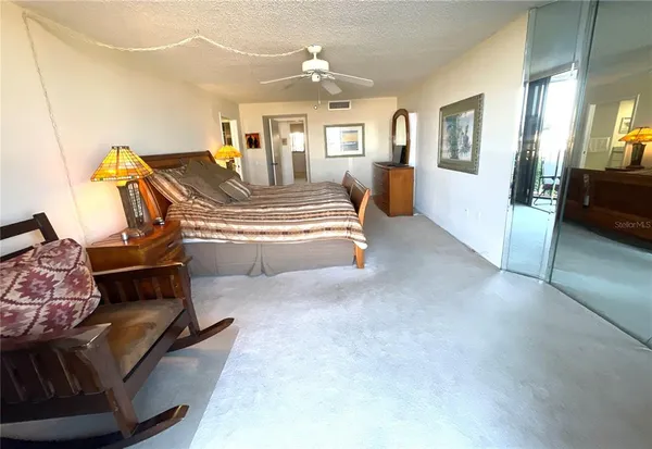 a patio with a table and chairs under an umbrella