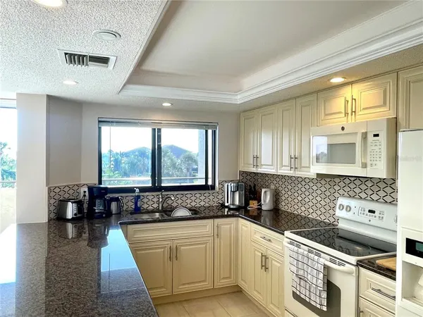 a kitchen with a stove a sink and a refrigerator