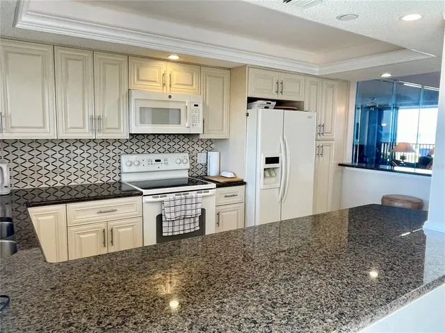 a living room with furniture a window and a chandelier