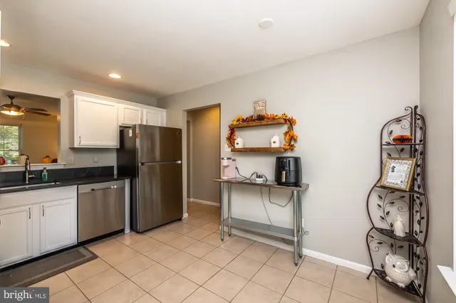 a kitchen with stainless steel appliances a sink cabinets and refrigerator