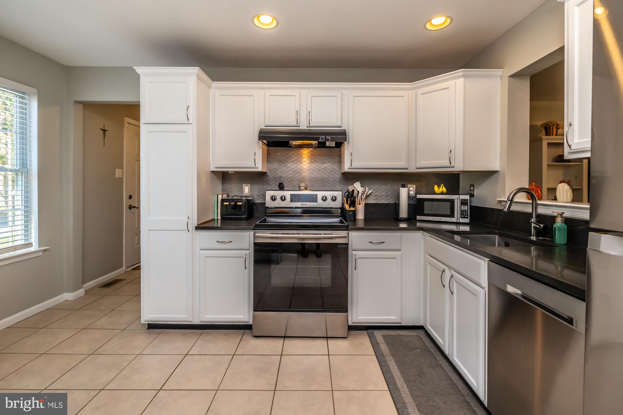 31 North Hawthorne Road Coatesville, PA 19320 - Photo 6 of 41 a kitchen with a stove sink and cabinets