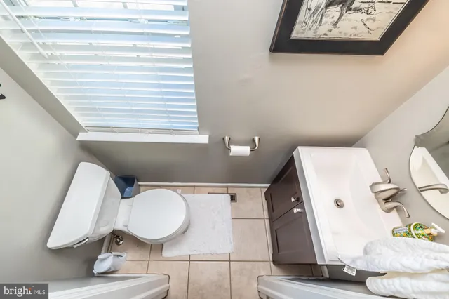 a bathroom with a toilet and a mirror