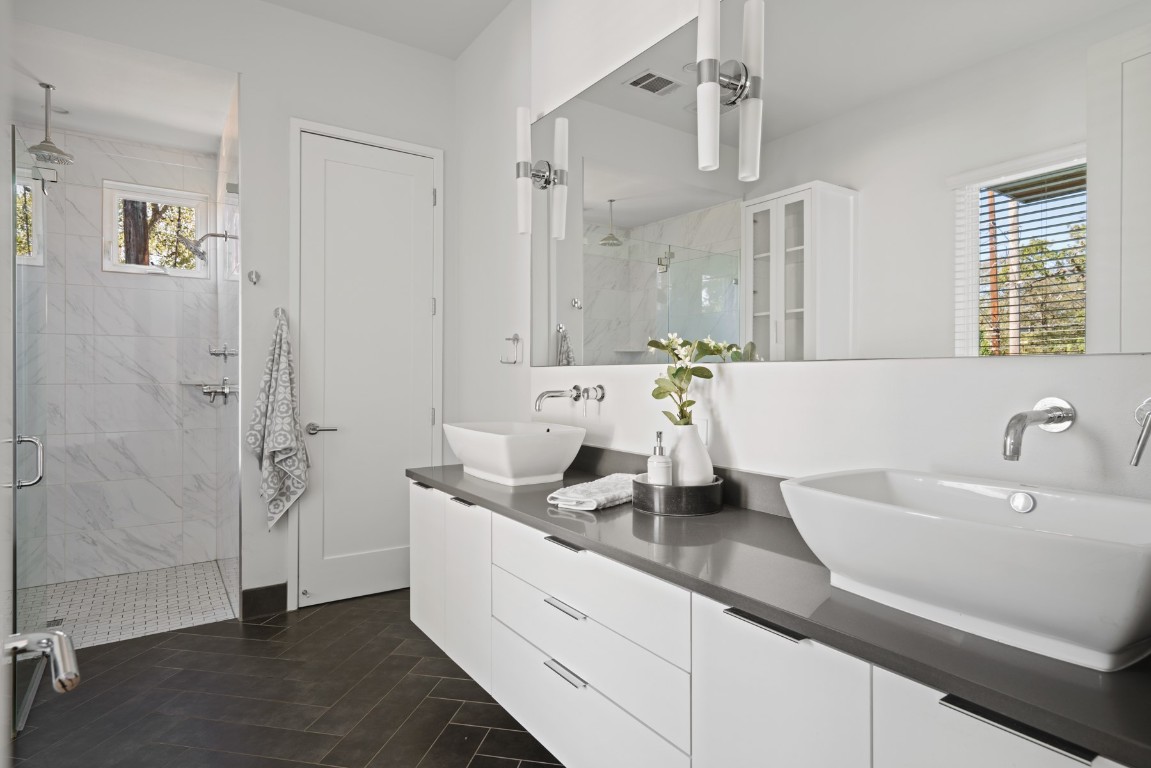2105 Enfield Road, Unit A Austin, TX 78703 - Photo 23 of 38 a spacious en suite bathroom with a double vanity sink a mirror and shower