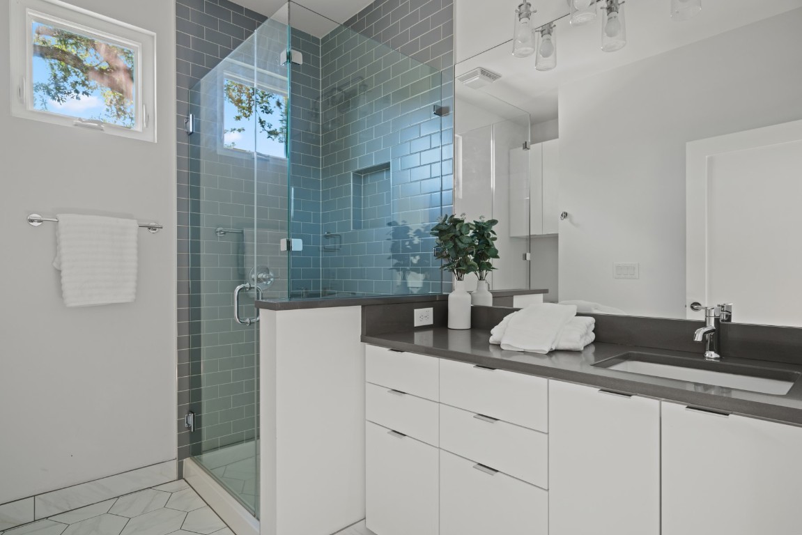 2105 Enfield Road, Unit A Austin, TX 78703 - Photo 27 of 38 a bathroom with a sink and a mirror