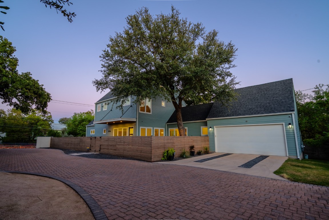 2105 Enfield Road, Unit A Austin, TX 78703 - Photo 3 of 38 a front view of a house with a yard and garage