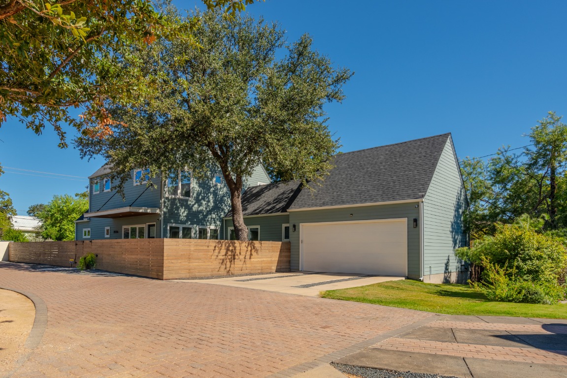 2105 Enfield Road, Unit A Austin, TX 78703 - Photo 4 of 38 a front view of a house with a yard and garage