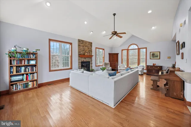 a large kitchen with kitchen island a sink counter space and a view of living room