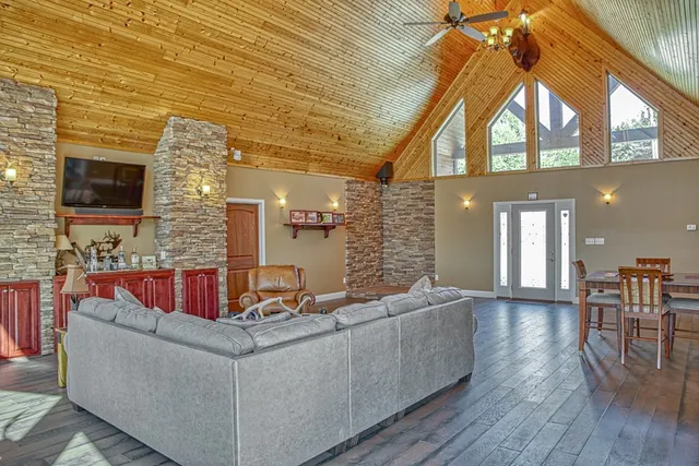 a living room with fireplace furniture and a flat screen tv