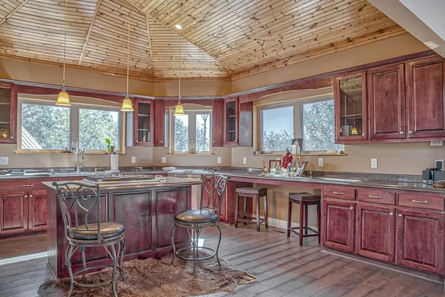 a kitchen with a sink cabinets and wooden floor
