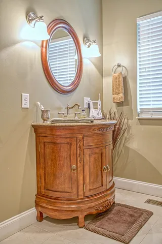 a bathroom with a mirror and vanity